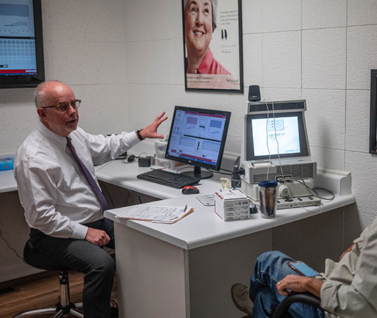 Dr. Vehr talking to a patient about hearing loss.